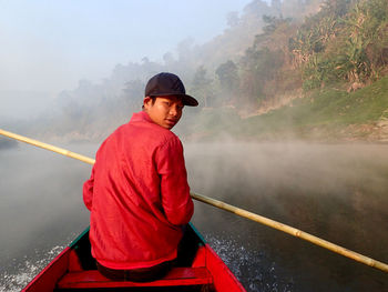 Rear view of man looking at river