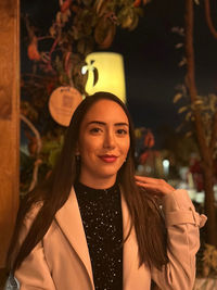 Portrait of young woman standing outdoors