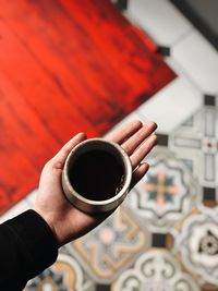 Cropped image of hand holding coffee cup