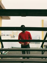 Rear view of man standing by railing