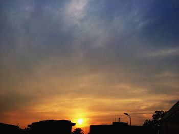 Low angle view of silhouette buildings against sky during sunset