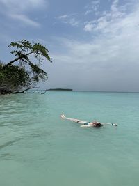 High angle view of man swimming in sea against sky