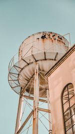 Low angle view of water tower against clear sky