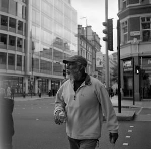 Full length of man standing on street in city