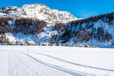 The village of isola in winter, on lake sils, engadin, switzerland.