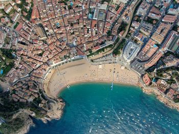 Aerial view of sea and buildings in city