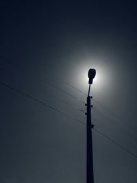 Low angle view of power lines against sky