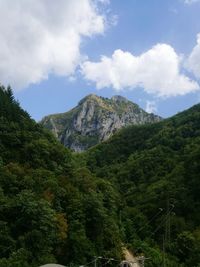 Low angle view of mountain against cloudy sky