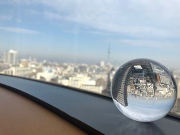 Close-up of glass building against sky