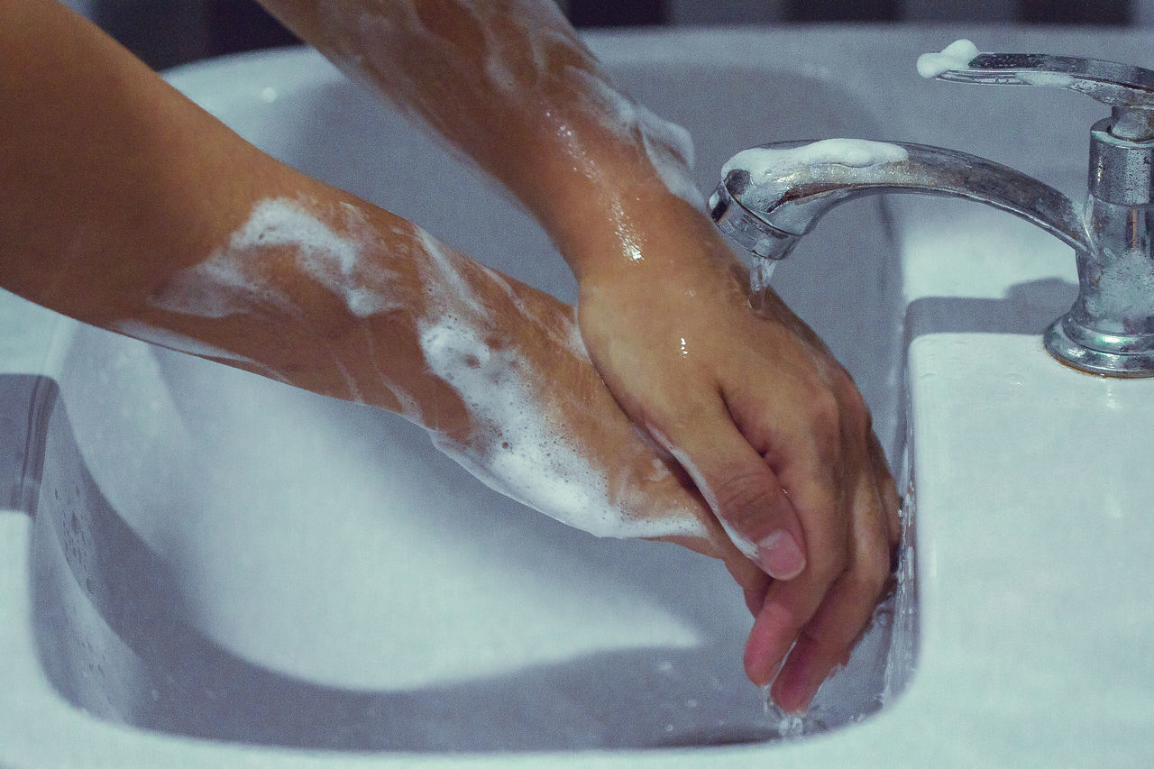 CLOSE-UP OF HAND TOUCHING WATER