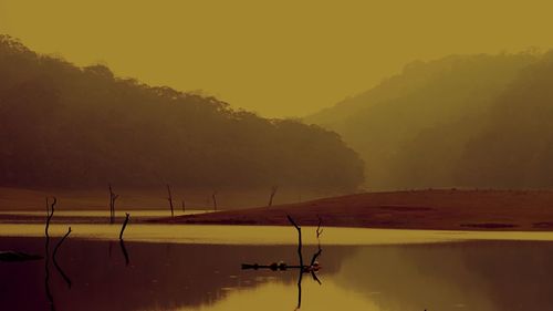 Scenic view of lake against sky during sunset