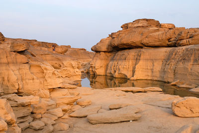 Low angle view of rock formations against sky