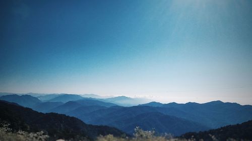 Scenic shot of mountain range against clear blue sky