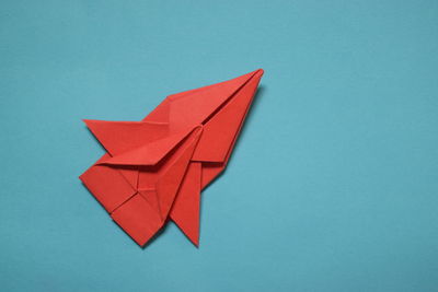 Close-up of paper flag against blue background