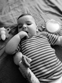 Close-up of baby girl with finger in mouth