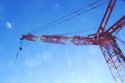 Low angle view of crane against sky