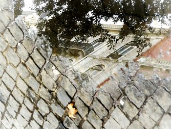 High angle view of stone wall by street in city