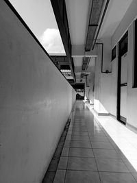 Empty footpath amidst buildings in city