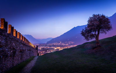 Scenic view of illuminated landscape against blue sky