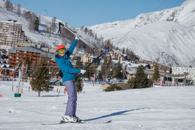 Full length of man skiing on snow covered mountain