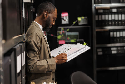 Side view of man using laptop