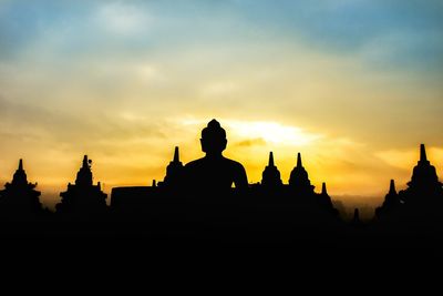 Silhouette temple against sky during sunset