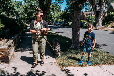 Full length of friends with children on tree