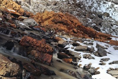 High angle view of rocks in river during winter