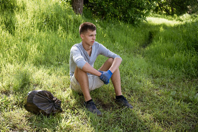 Young man resting after cleaning the park