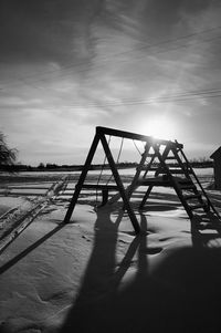 Shadow of tree on snow covered landscape