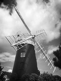 Low angle view of traditional windmill against sky