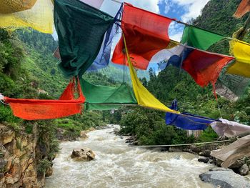 Colorful flags hanging over river