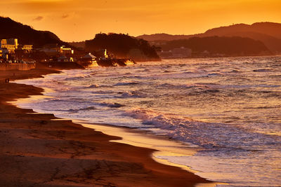 Scenic view of beach against sky during sunset