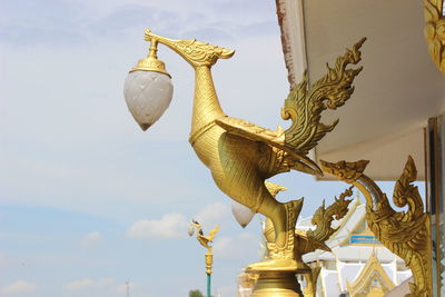 Low angle view of angel statue against sky