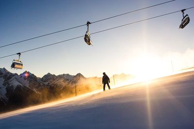 Silhouette of snowboarder on slope