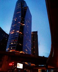 Low angle view of modern building against sky at night