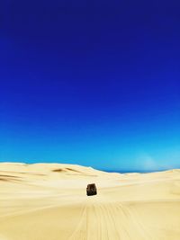 Scenic view of desert against clear blue sky