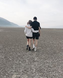 Rear view of woman standing on shore