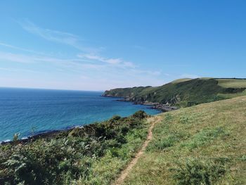 Scenic view of sea against blue sky