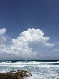 Scenic view of sea against cloudy sky