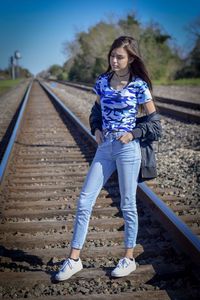 Full length of woman standing on railroad track