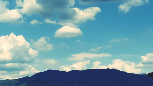 Scenic view of mountains against cloudy sky