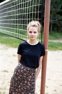 Portrait of a beautiful young woman standing outdoors