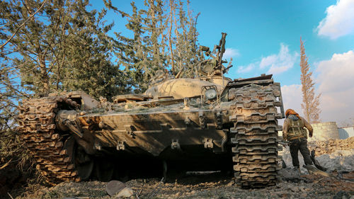 Low angle view of abandoned vehicle against sky