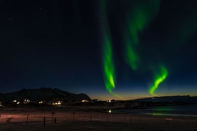 Scenic view of illuminated mountains against sky at night