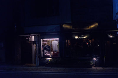 Illuminated text on street at night