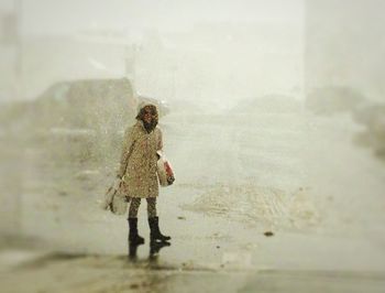 Full length of woman standing in water