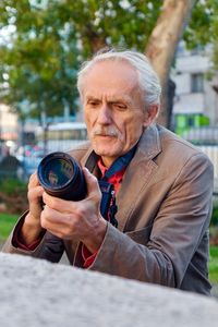 Portrait of man holding camera