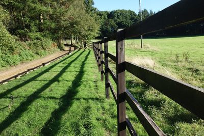 Fence on field against sky