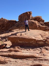 Full length of man on rock against sky